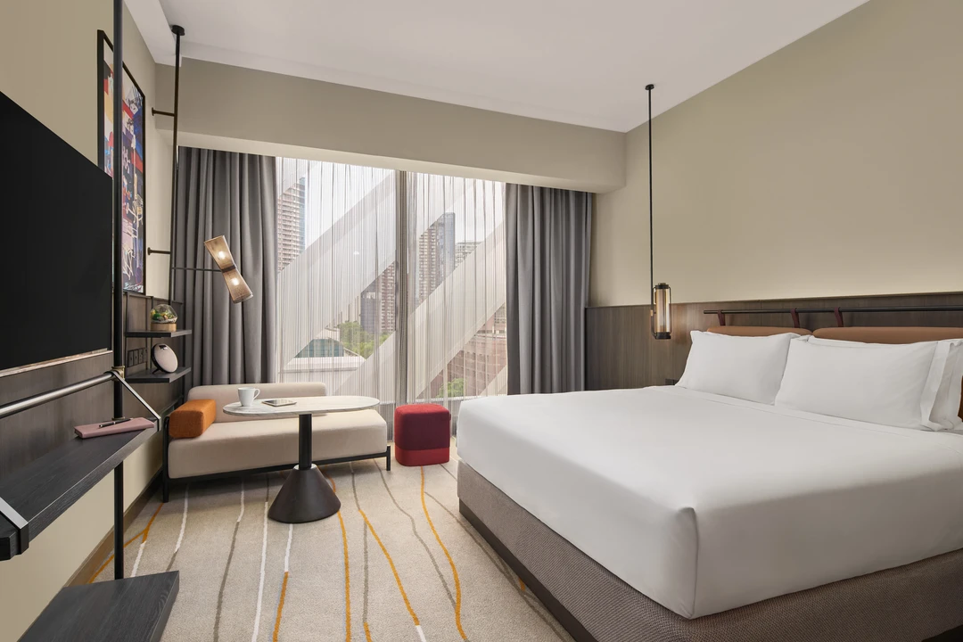 Deluxe premiere king room with closed sheers for warm ambient mood