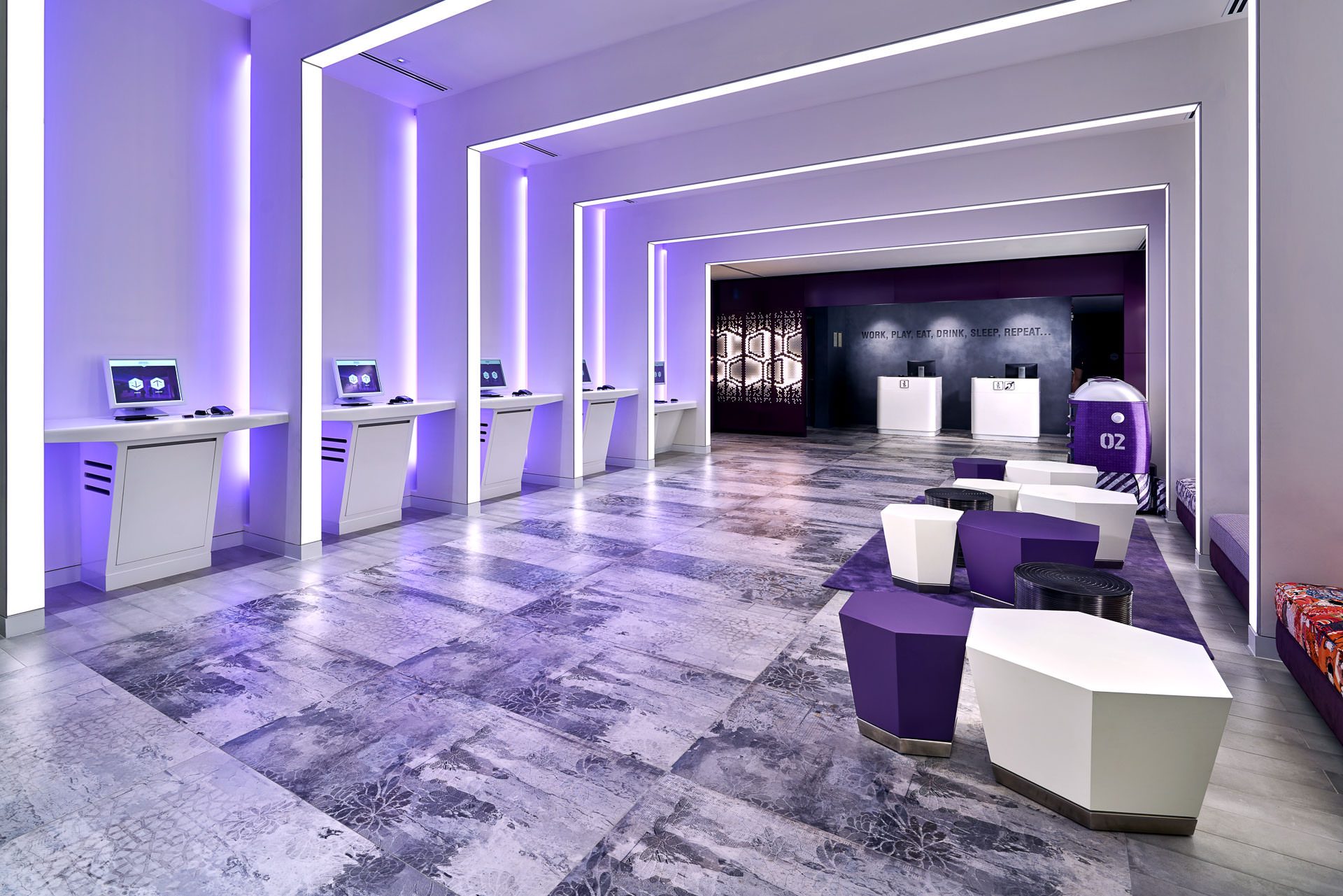 YOTEL Singapore lobby with purple LED lighting and robot concierges