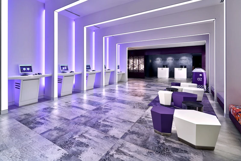 YOTEL Singapore lobby with purple LED lighting and robot concierges