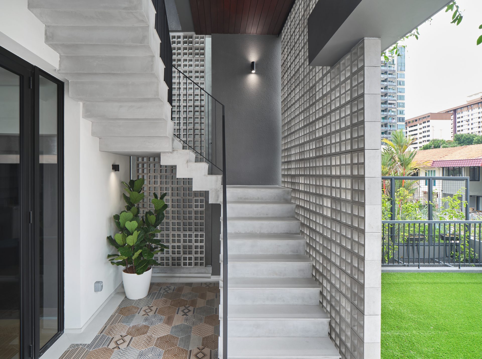 Concrete staircase and greenery in contemporary residential architecture.