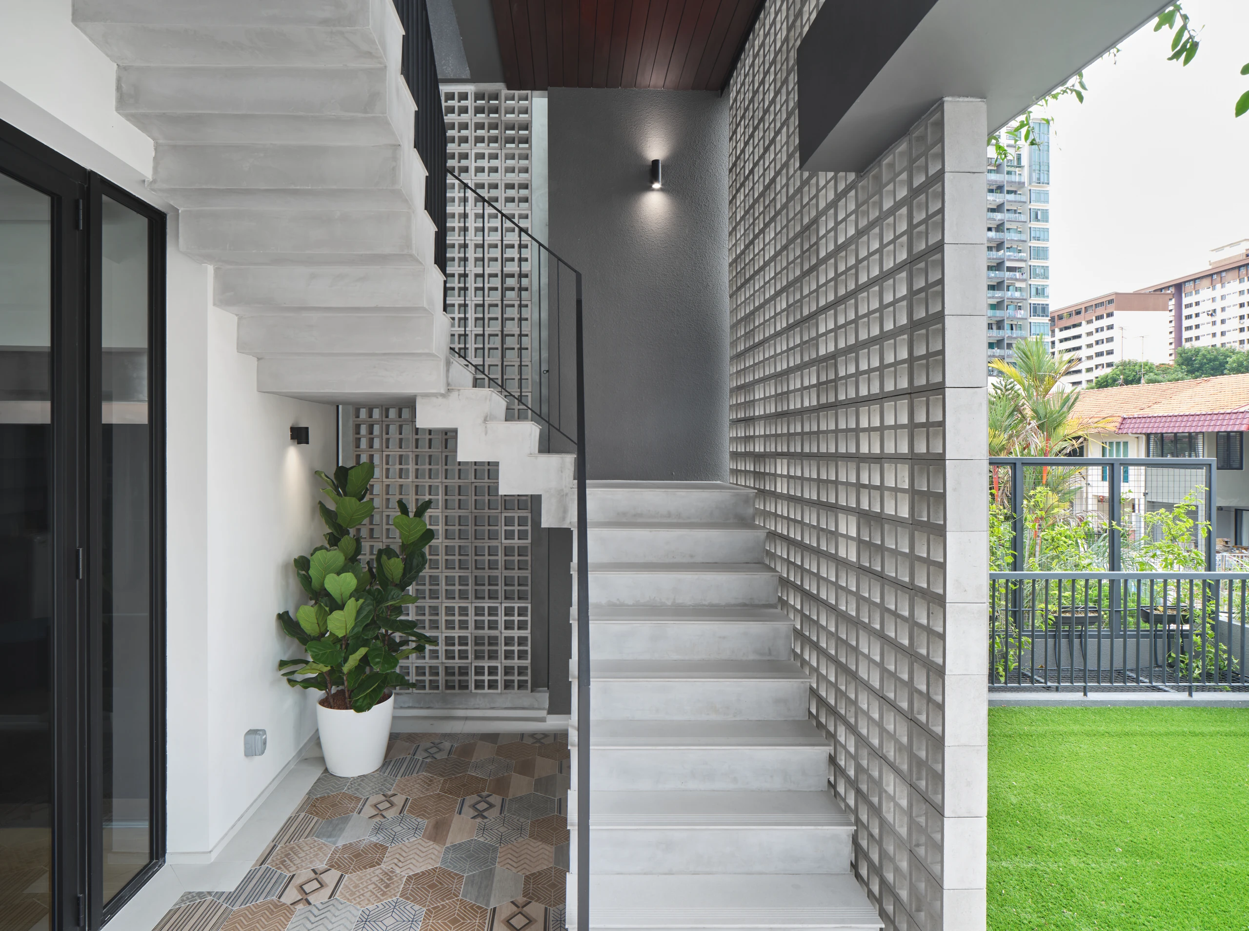 Concrete staircase and greenery in contemporary residential architecture.