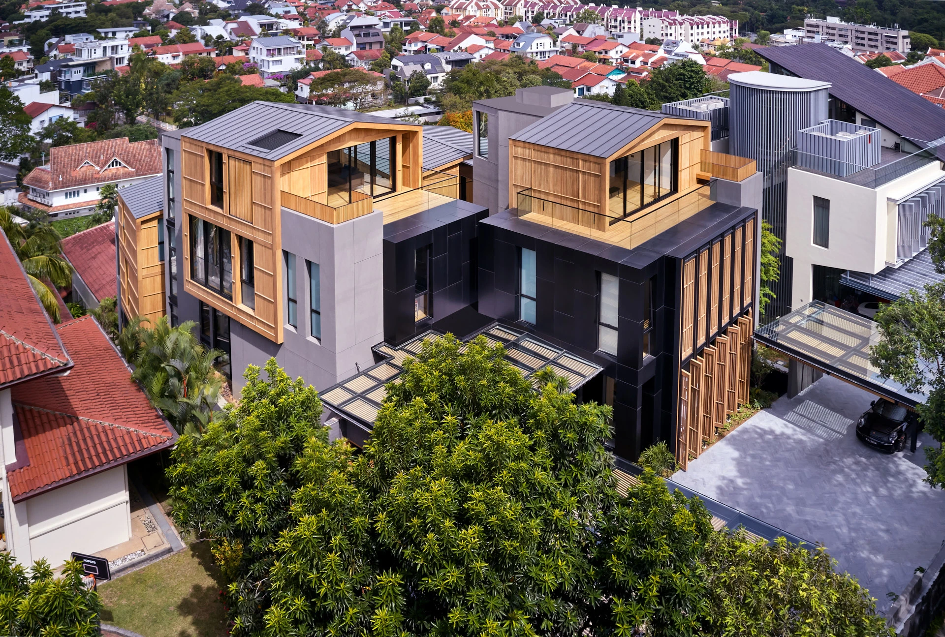 Rear view of twin timber penthouses with glass pergola entrance