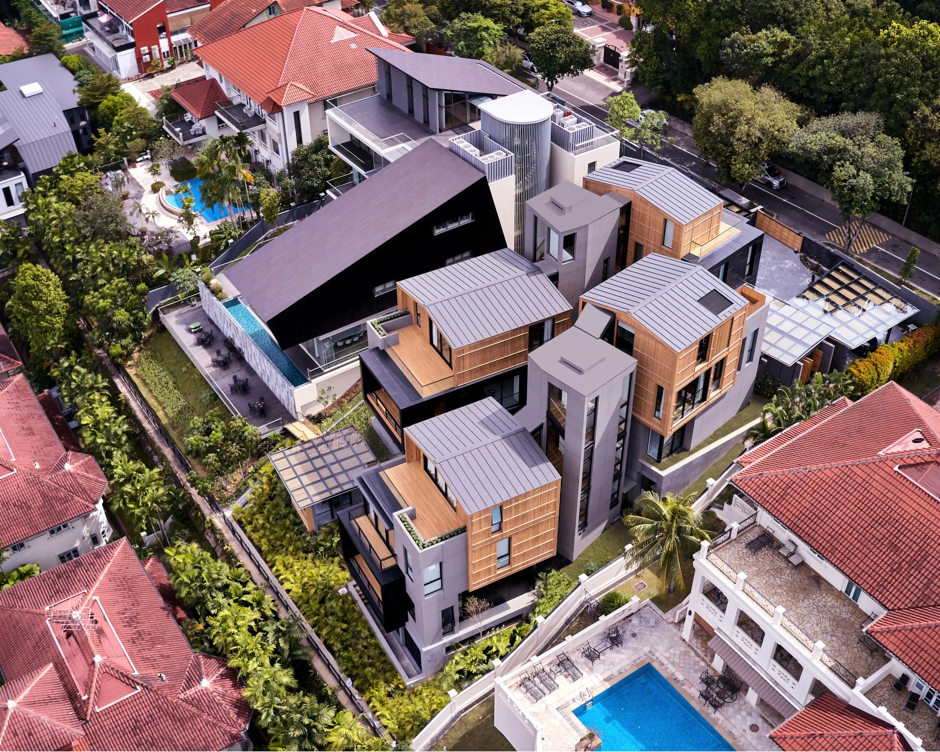 Aerial of standing-seam roofs, timber screens and suburban rooftops