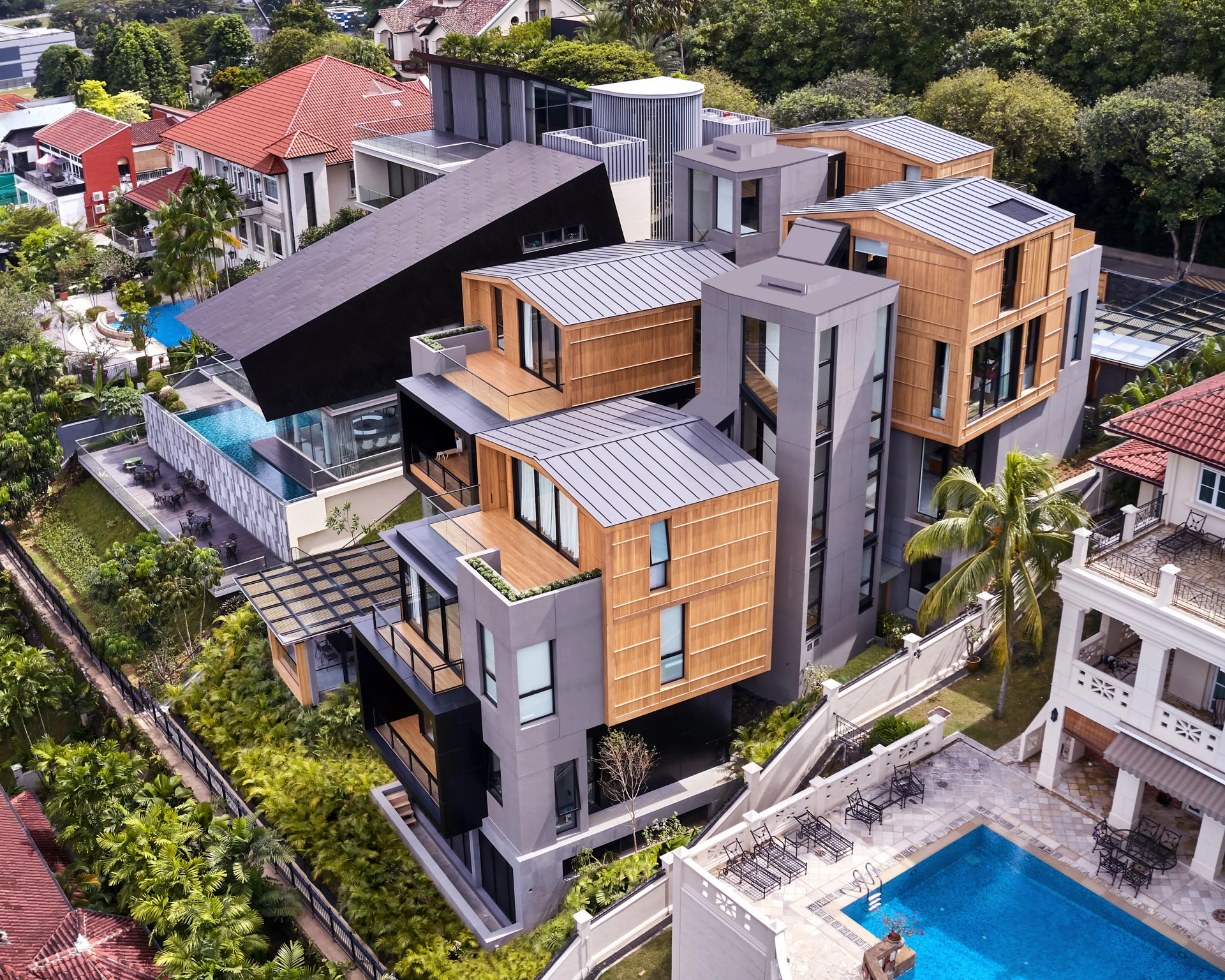 Rear aerial of zinc rooftops, glass pergolas and green terraces