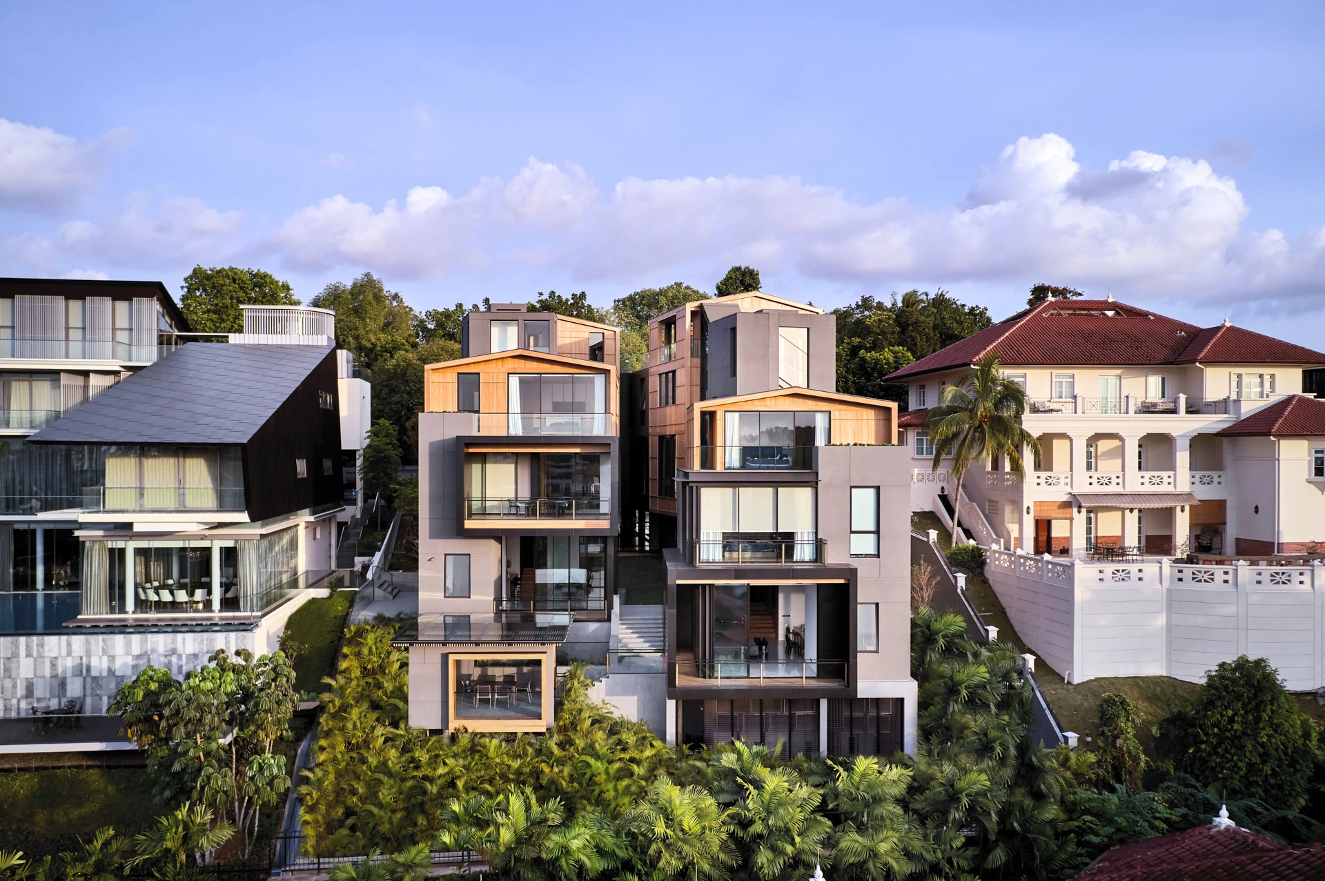 Cantilevered timber volumes with glass balustrades and tropical landscaping