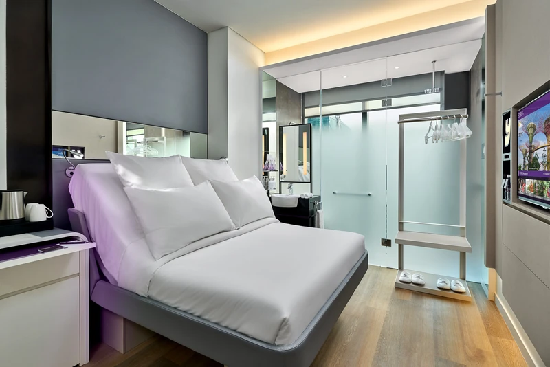Queen cabin with purple headboard, frosted shower and warm wood floor