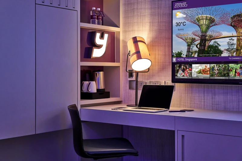 Work desk with laptop, drum lamp and smart TV concierge screen