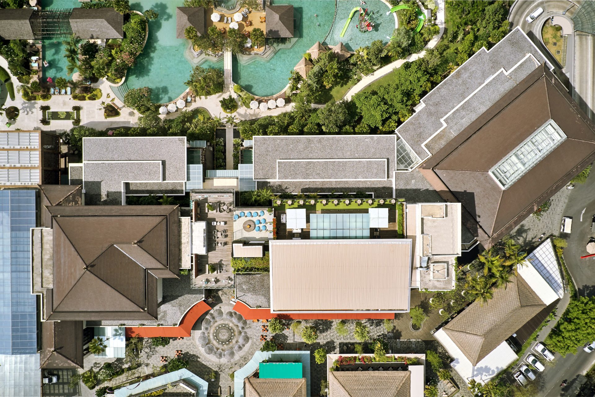 Overhead drone shot of turf terrace, bar and mosaic dining area
