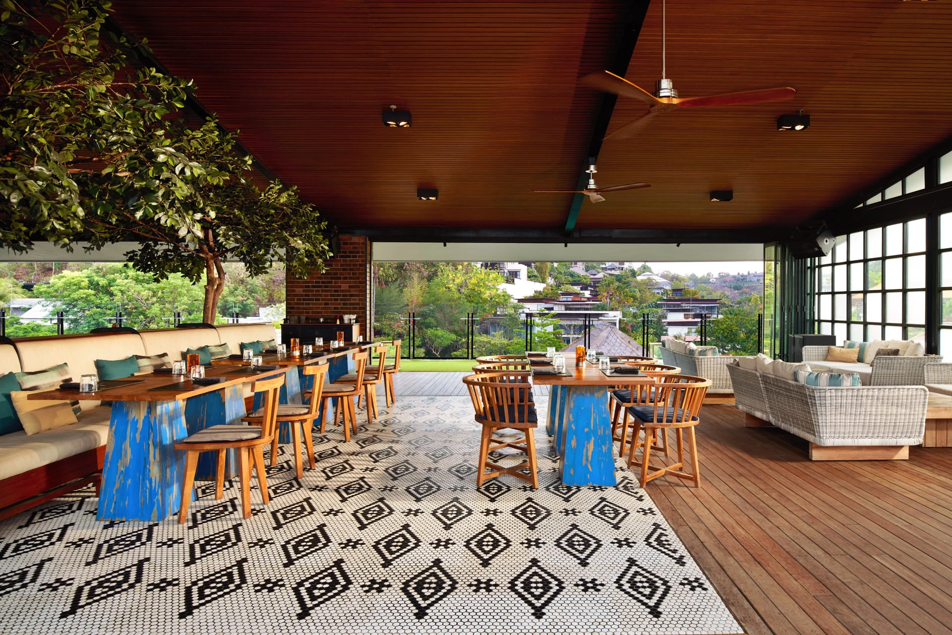 Open-sided dining with timber ceiling, mosaic floor and hillside views