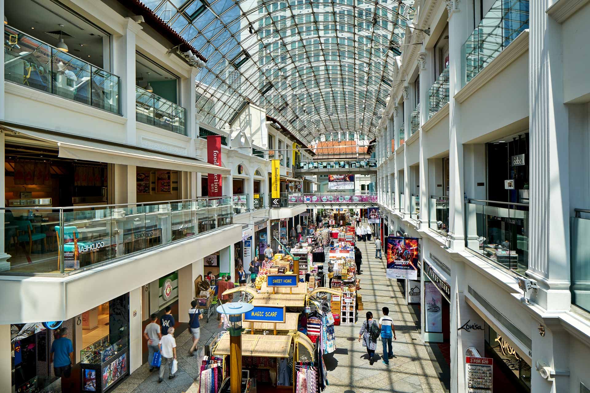 Multi-level arcade with market stalls and curved glass roof - Bugis Junction Singapore architectural photography