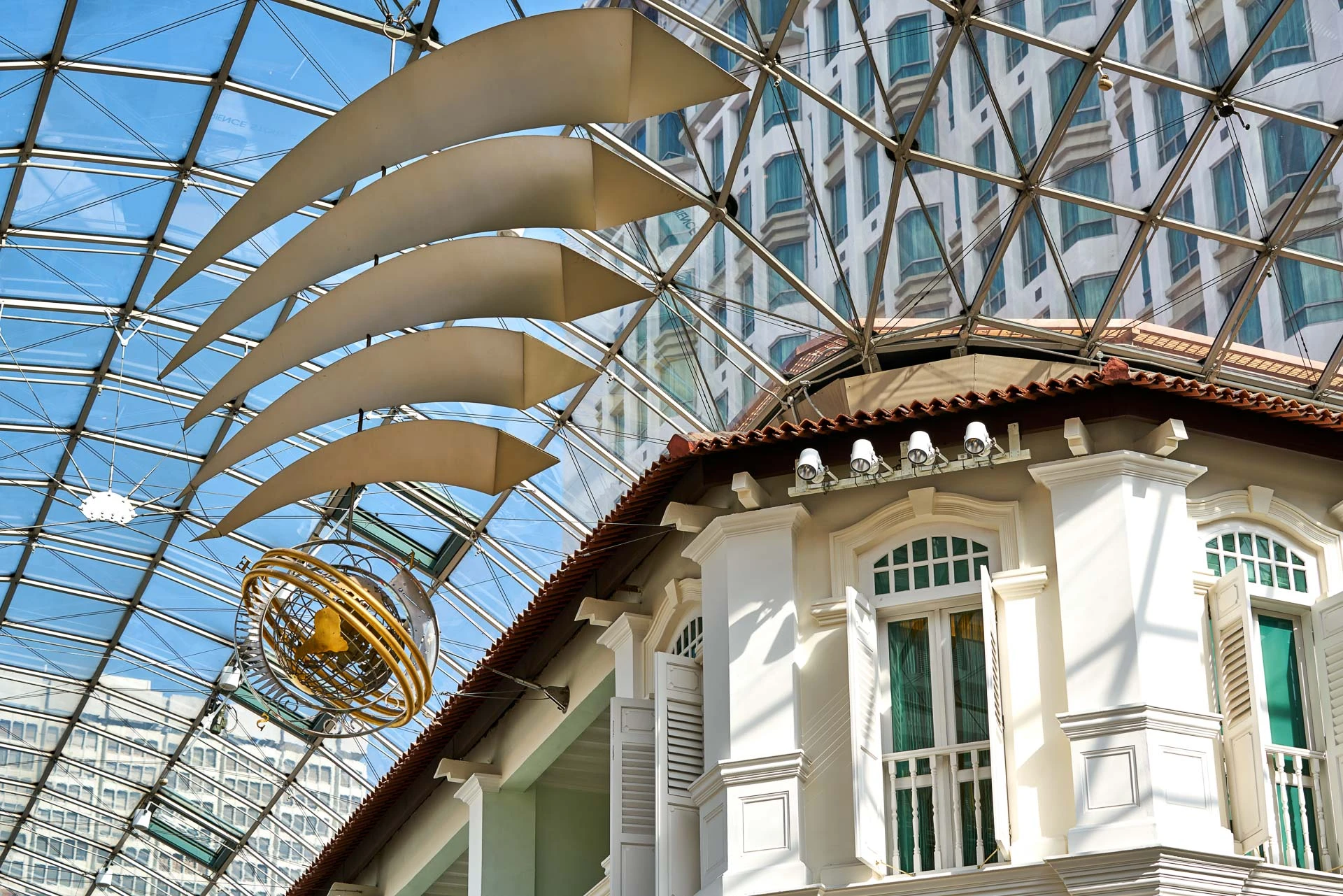 Armillary sphere sculpture and fabric baffles in glass atrium - Bugis Junction Singapore architectural photography