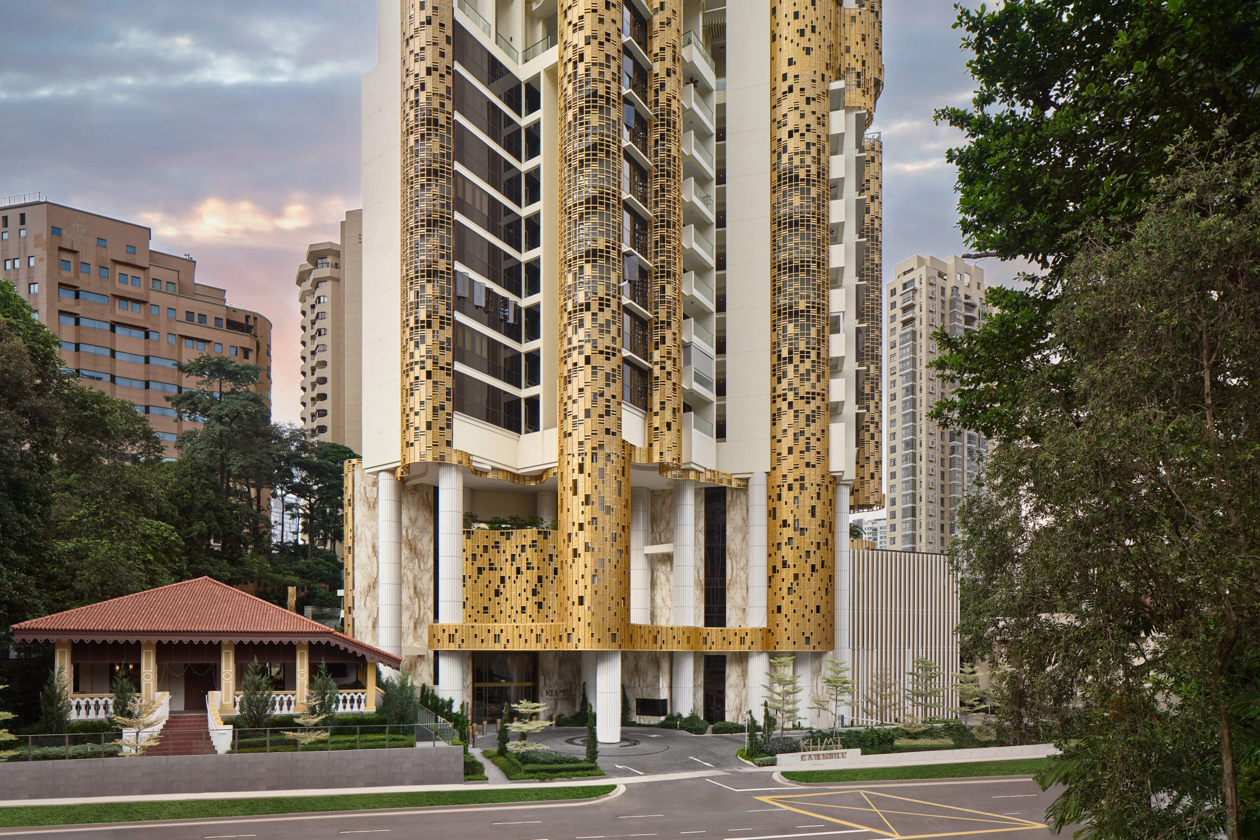 Klimt Cairnhill tower at dusk with Atlas Concorde gold mosaic tile facade columns and marble-effect porcelain cladding, Singapore