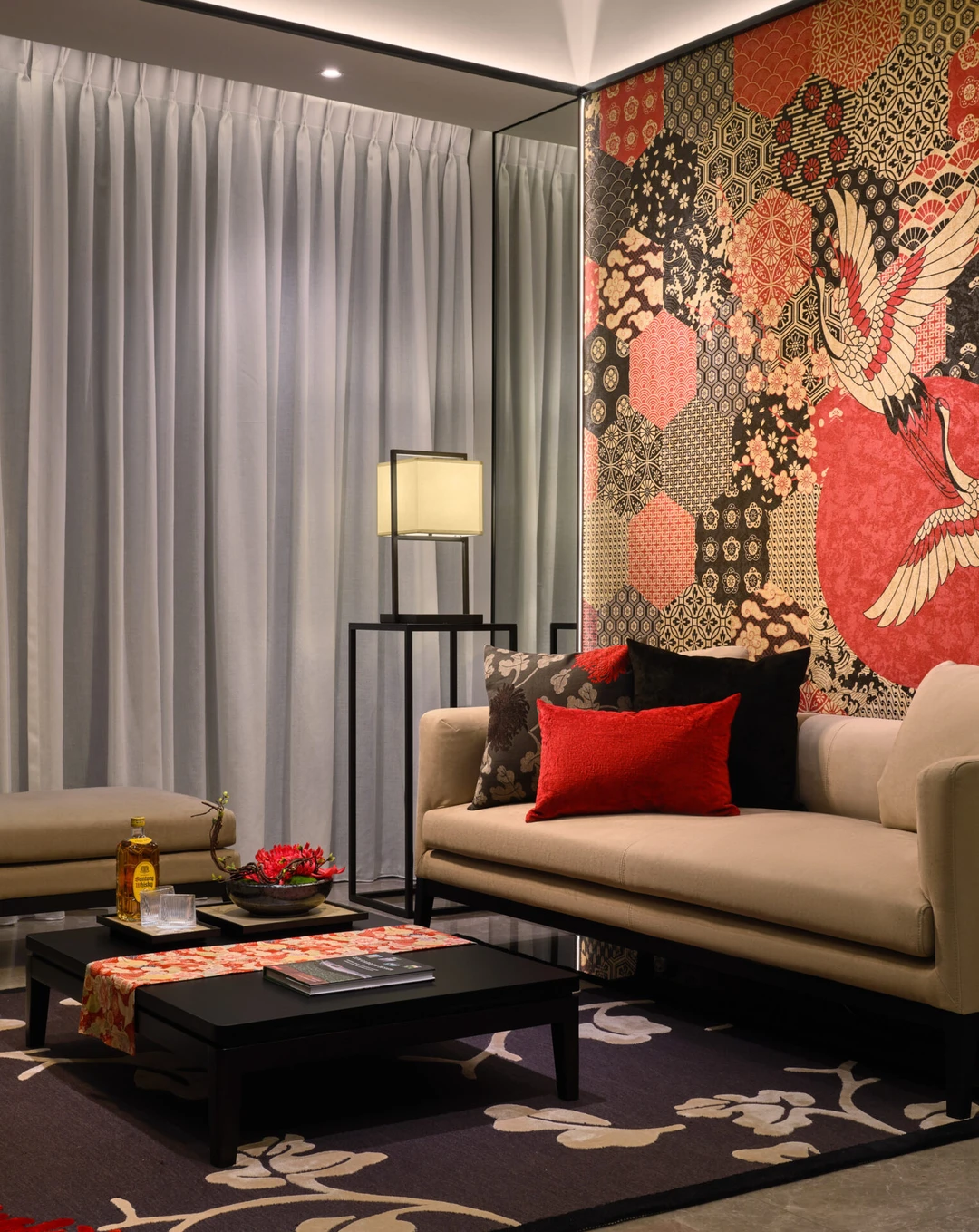Detail with brocade pillow, spider lily arrangement and warm lamp glow