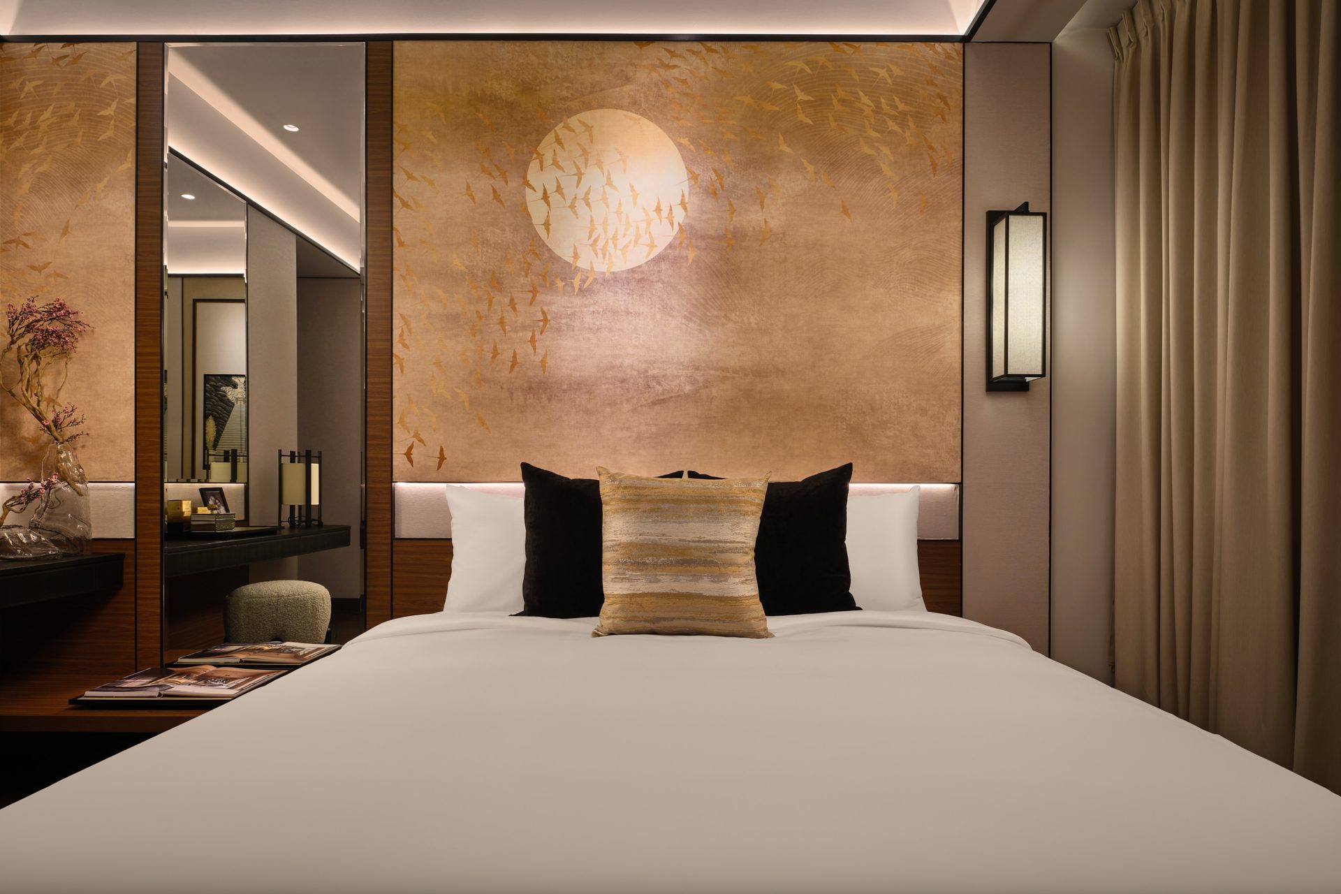 Boulevard 88 Interior Photography Singapore 4 - Bedroom 1 Point perspective of bed with pillows and patterned wall with sun and birds