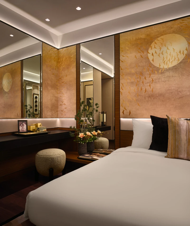 Bedroom with gold bird panels, ikebana and recessed glow