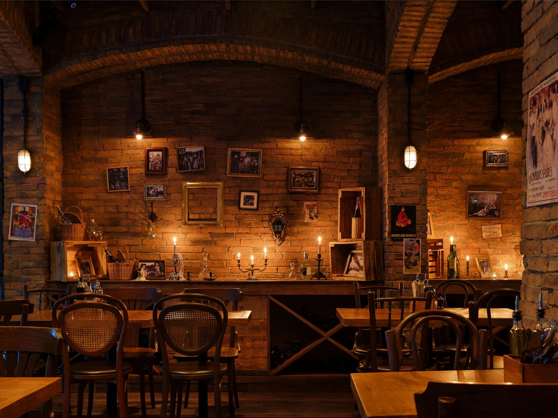 Brick cellar alcove with arched vaulting, candelabras and amber lighting — Cantina Bangkok interior photography