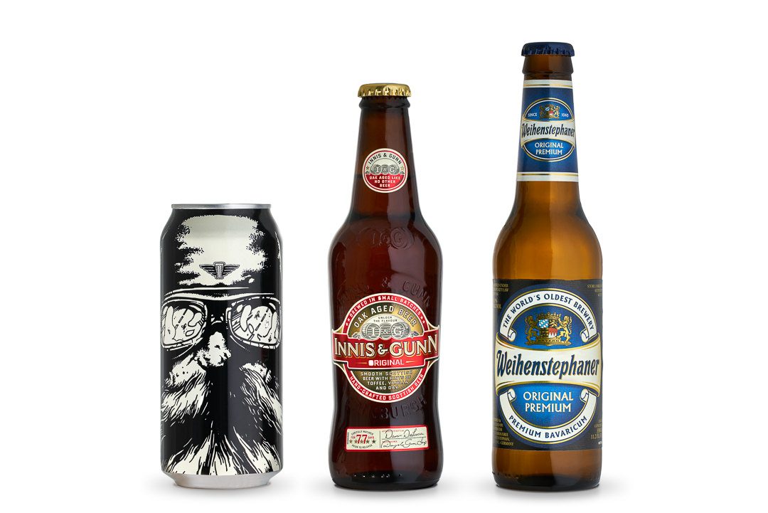 Three beers on a white background: a black illustrated craft beer can, an amber Innis and Gunn bottle, and a Weihenstephaner lager bottle.