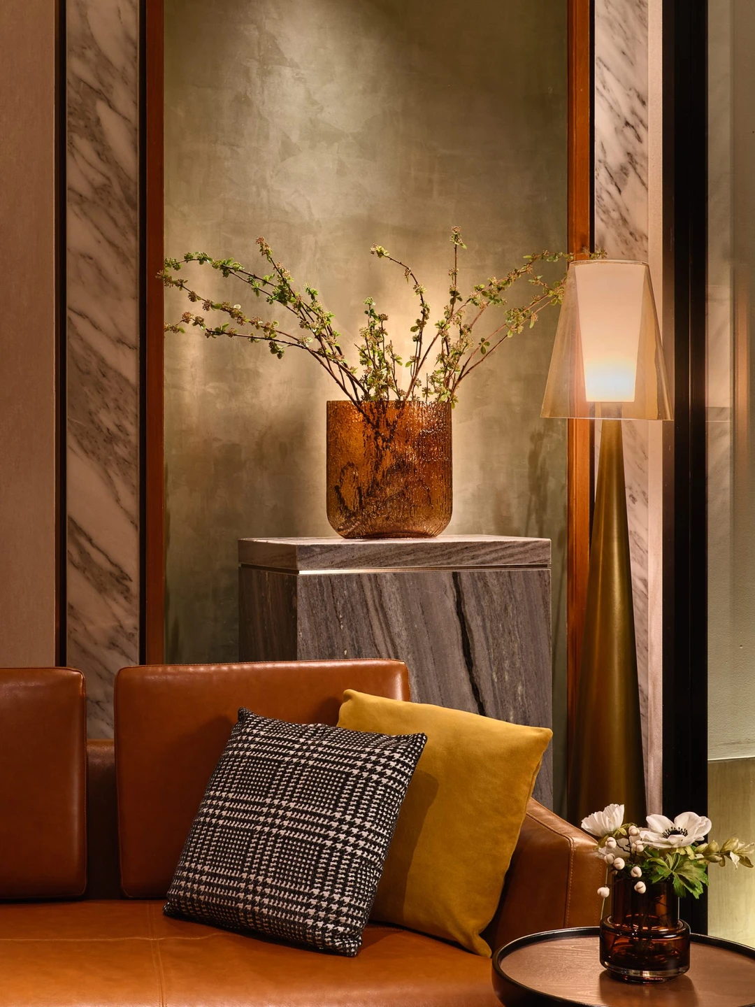 Fraser Suites Sukhumvit lounge detail with houndstooth cushions and amber vase