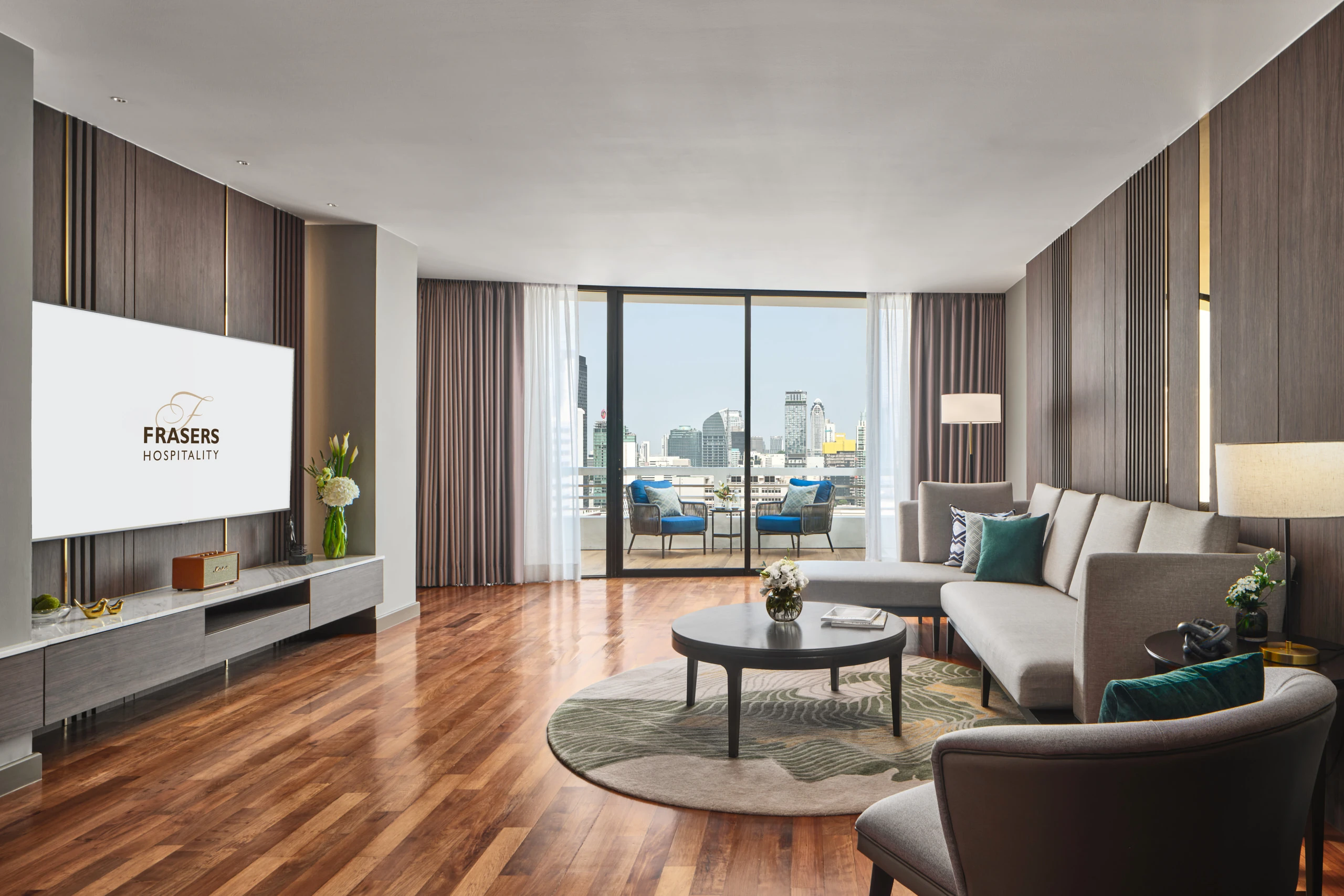 Penthouse living room with sectional sofa, balcony and city views