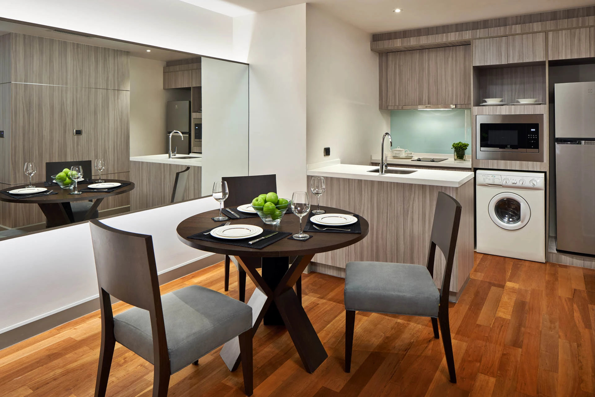 Compact kitchen-dining with mint backsplash and wall mirror