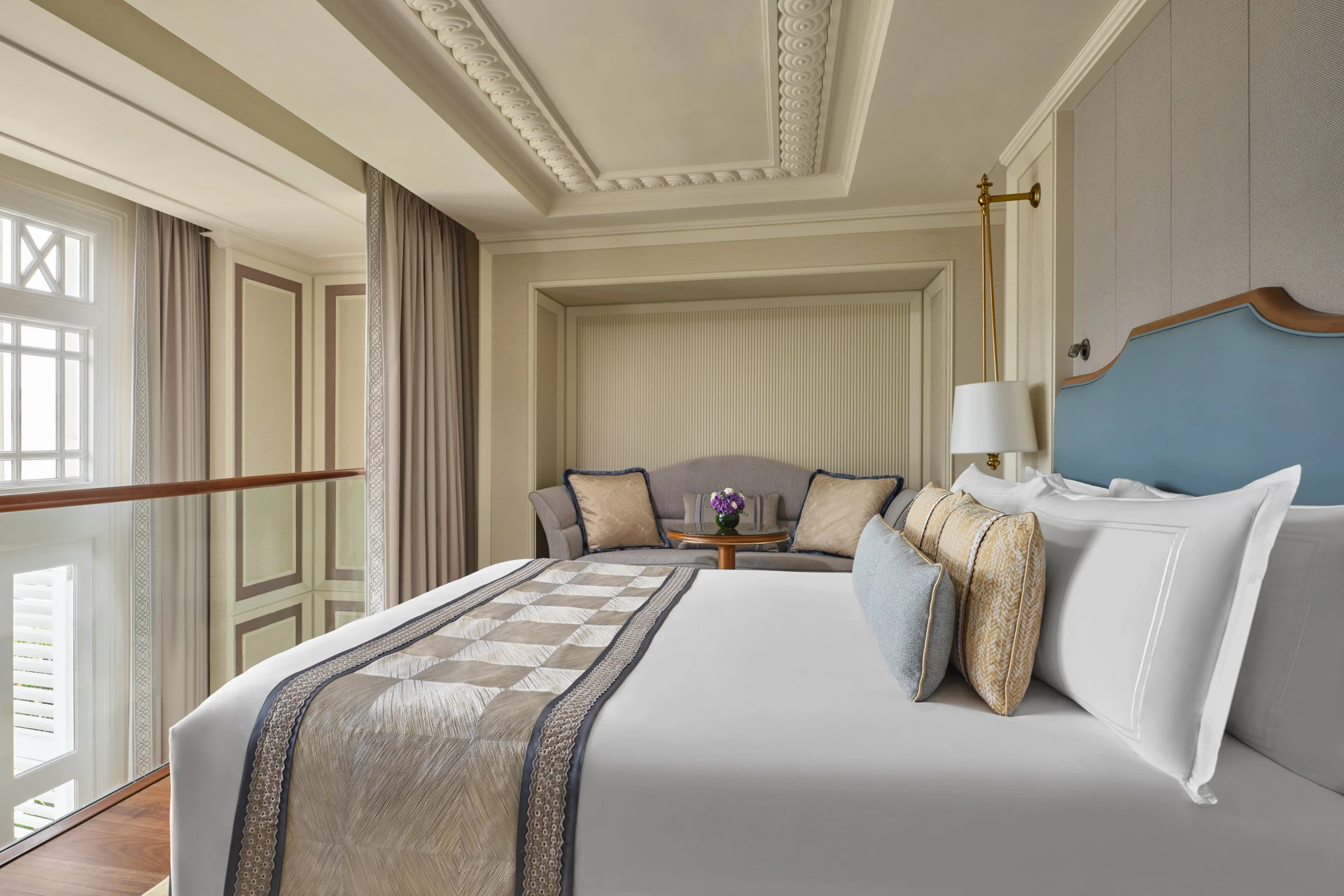 King bedroom with blue headboard, geometric runner and reading alcove