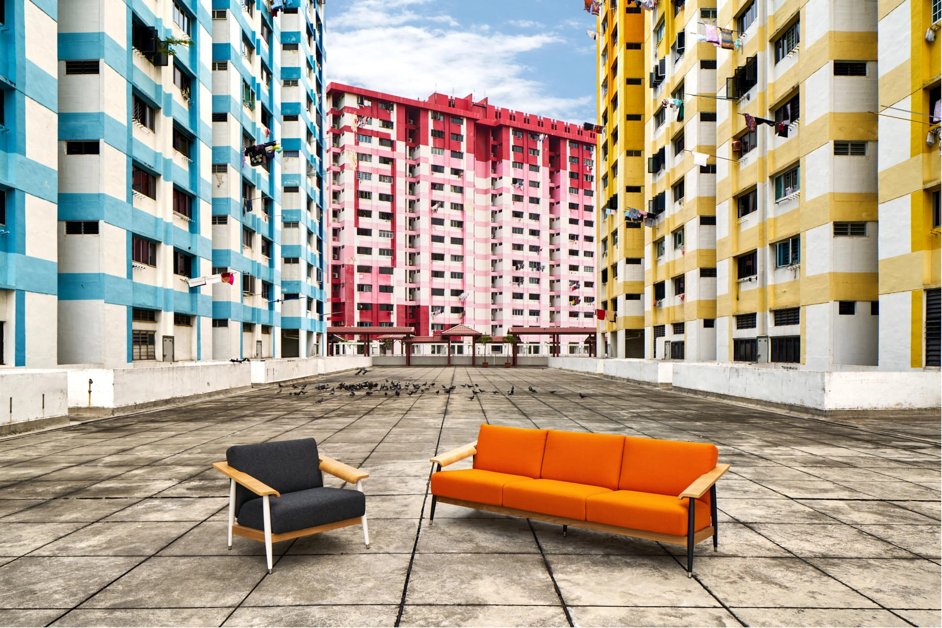 Armchair and sofa staged before colourful HDB tower blocks at Rochor Centre