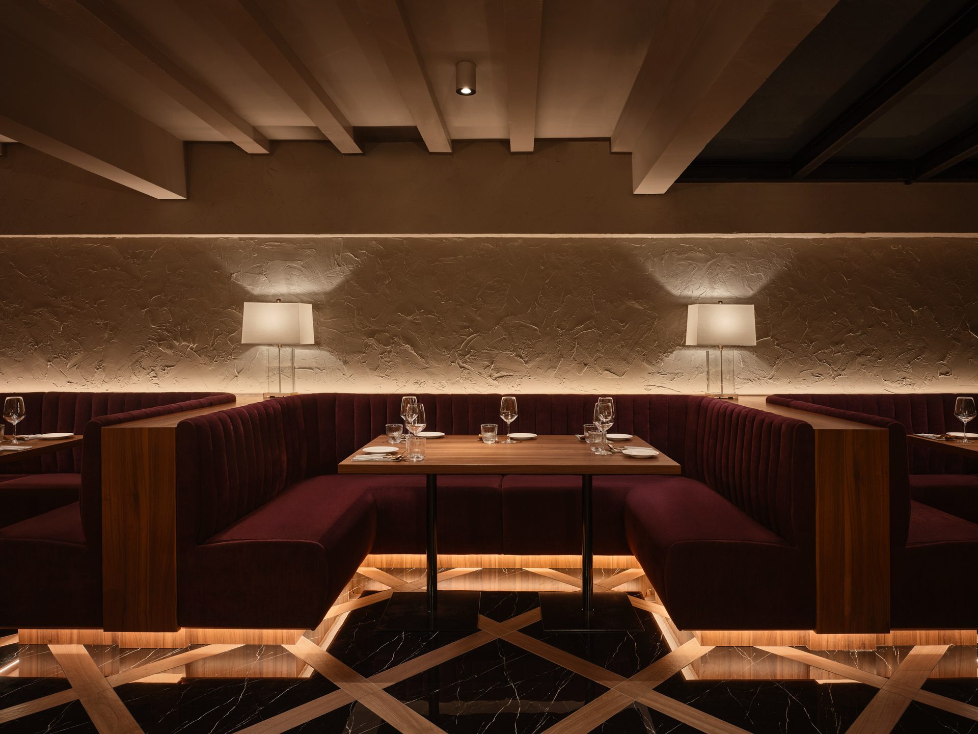 Gotti Singapore intimate booth seating with warm ambient lighting and textured wall details
