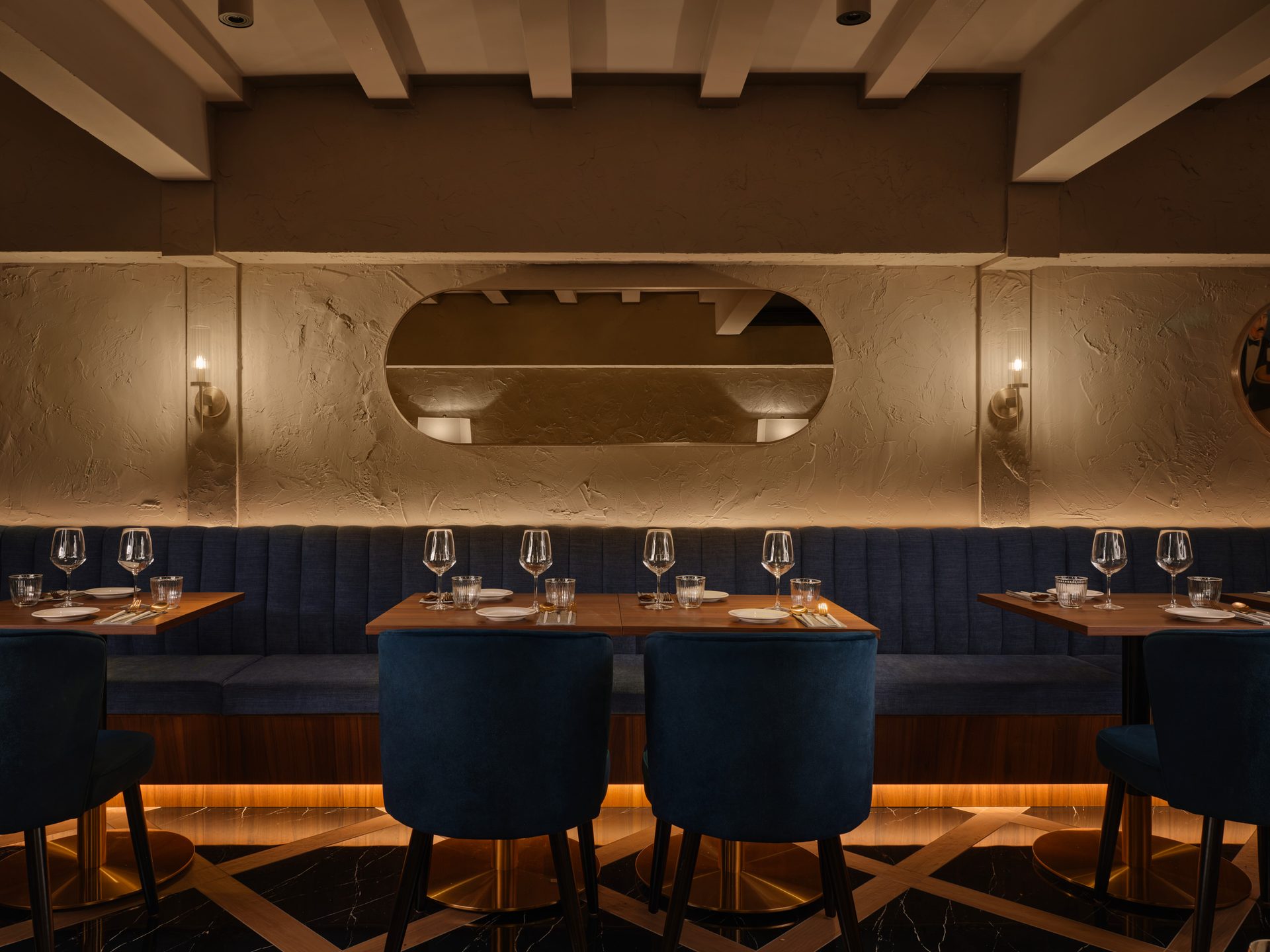 Gotti Singapore dining setup with deep blue chairs and contemporary decor