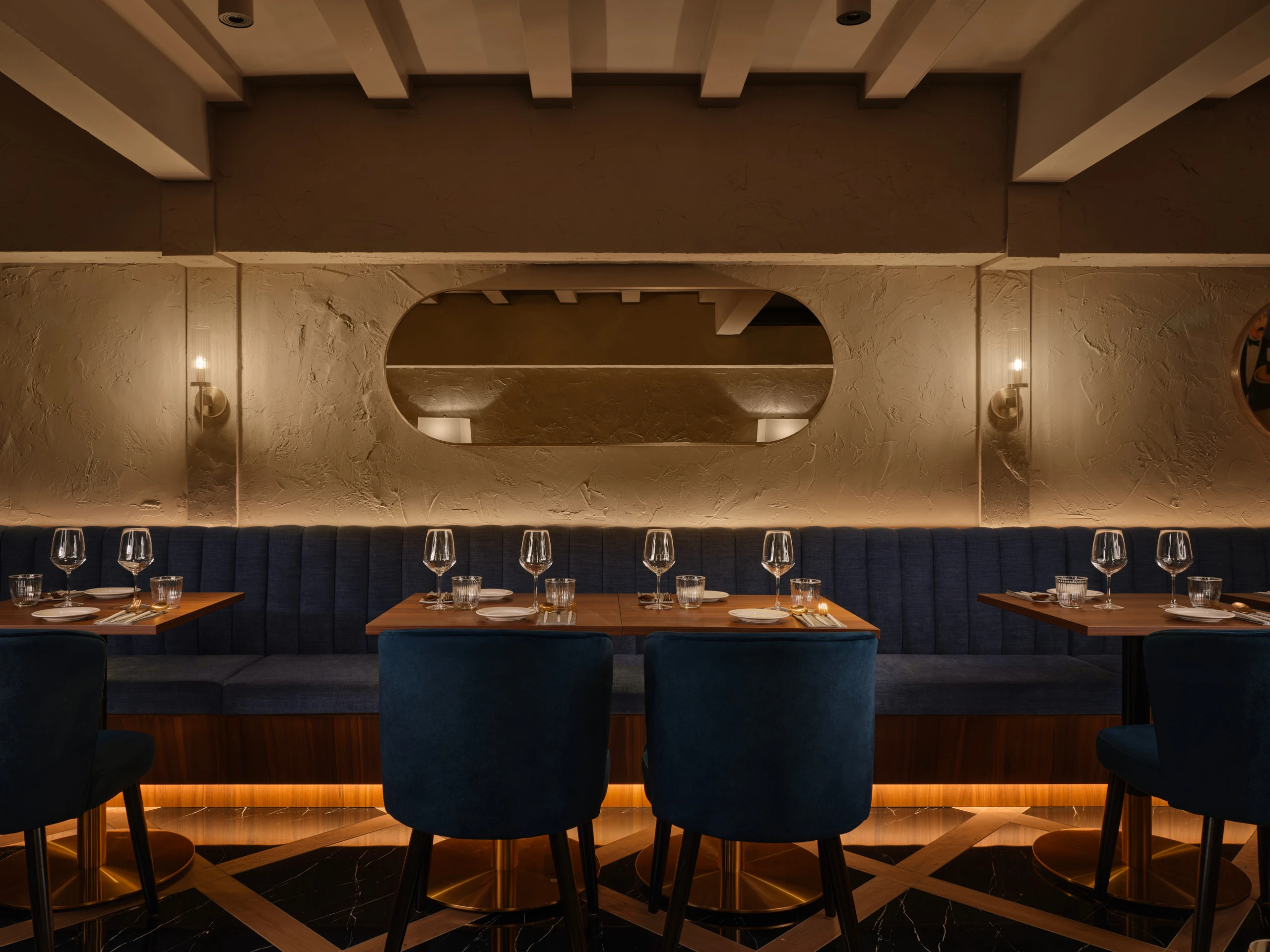 Gotti Singapore dining setup with deep blue chairs and contemporary decor