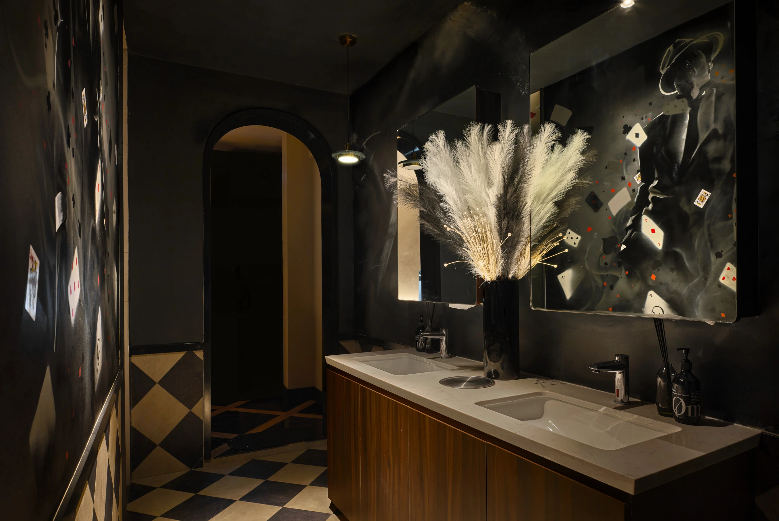 Gotti Singapore moody restroom with modern decor and elegant floral arrangements