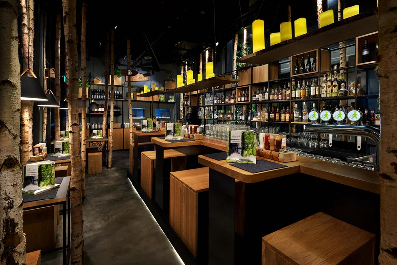 Dusk commercial restaurant photography of Hans Im Gluck in Singapore, designed by WOLF. The exterior shot highlights the glowing, warm interior and inviting ambiance at night.