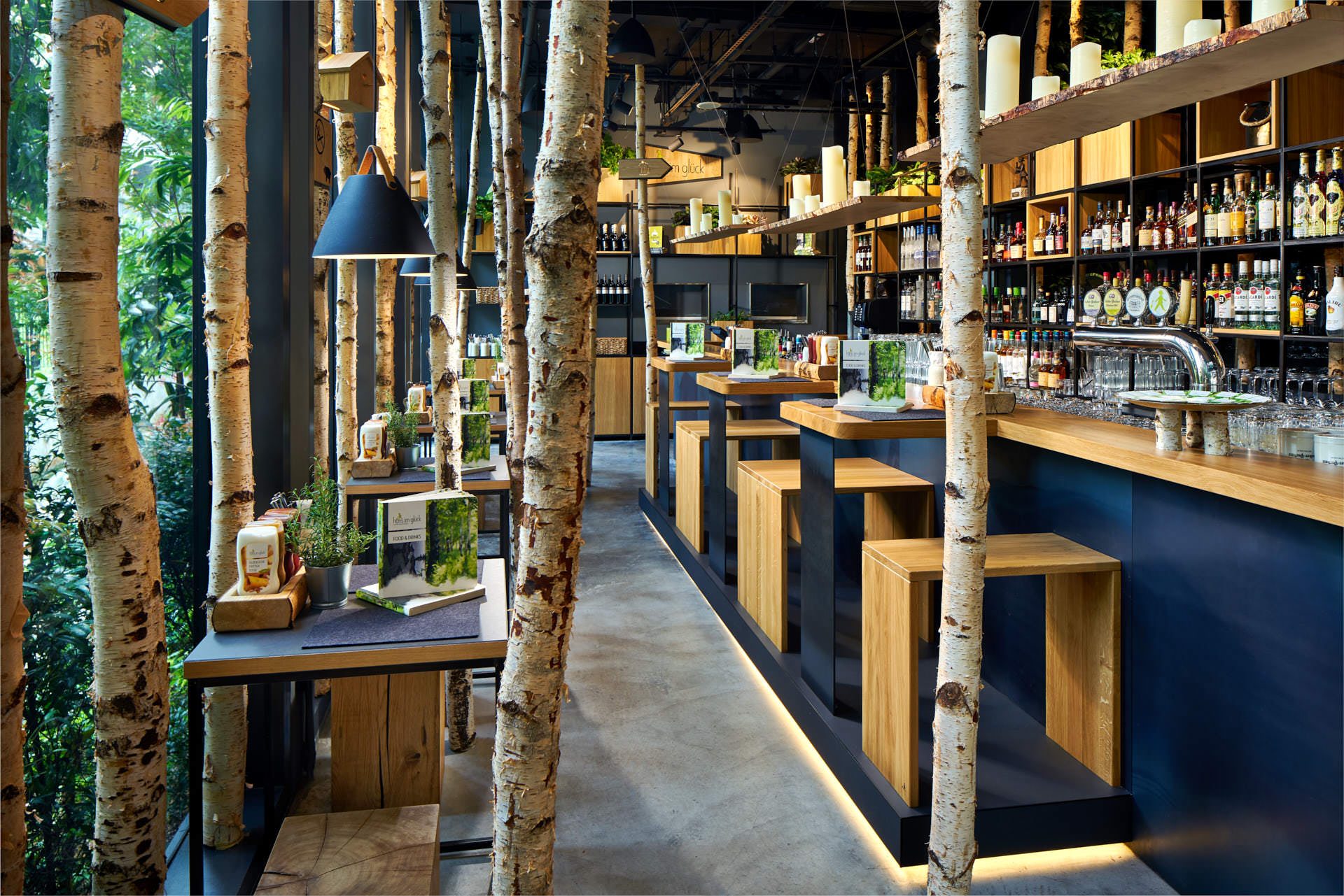 Commercial interior photography of Hans Im Gluck by WOLF, showing a pathway between dining tables, emphasizing spatial flow and design details.