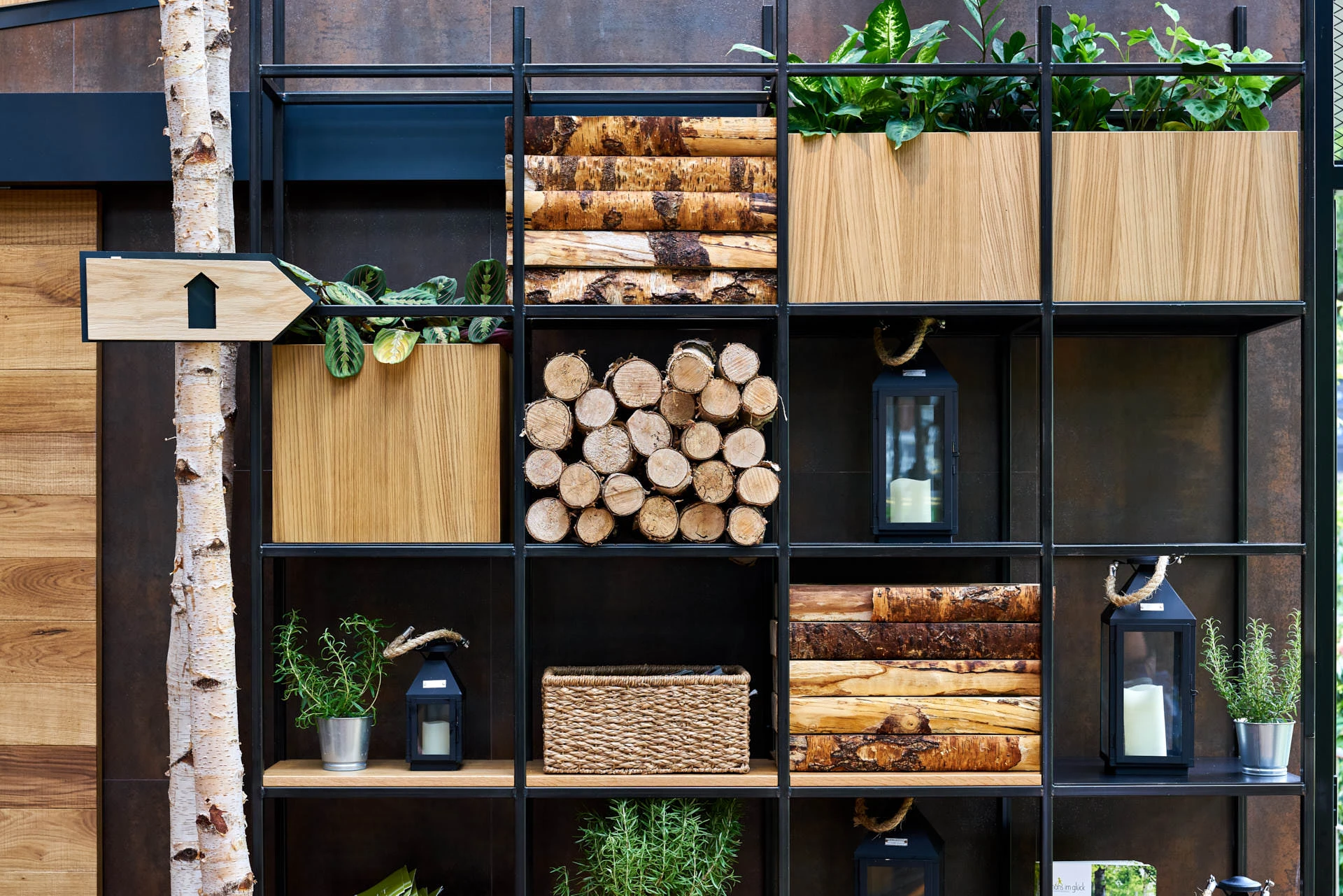Detail restaurant photography showing custom shelving filled with decorative logs and plants, part of Hans Im Gluck's WOLF-designed interior.