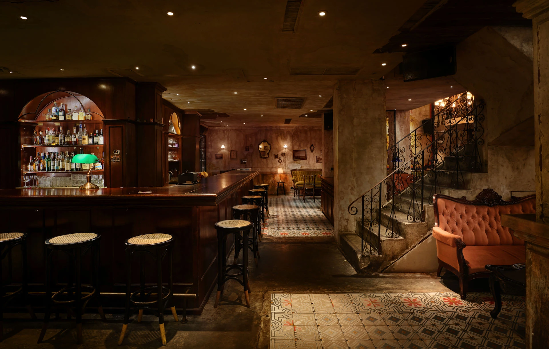 Mahogany bar with arched bottle display, bentwood stools and encaustic tiles — Havana Social Bangkok bar photography