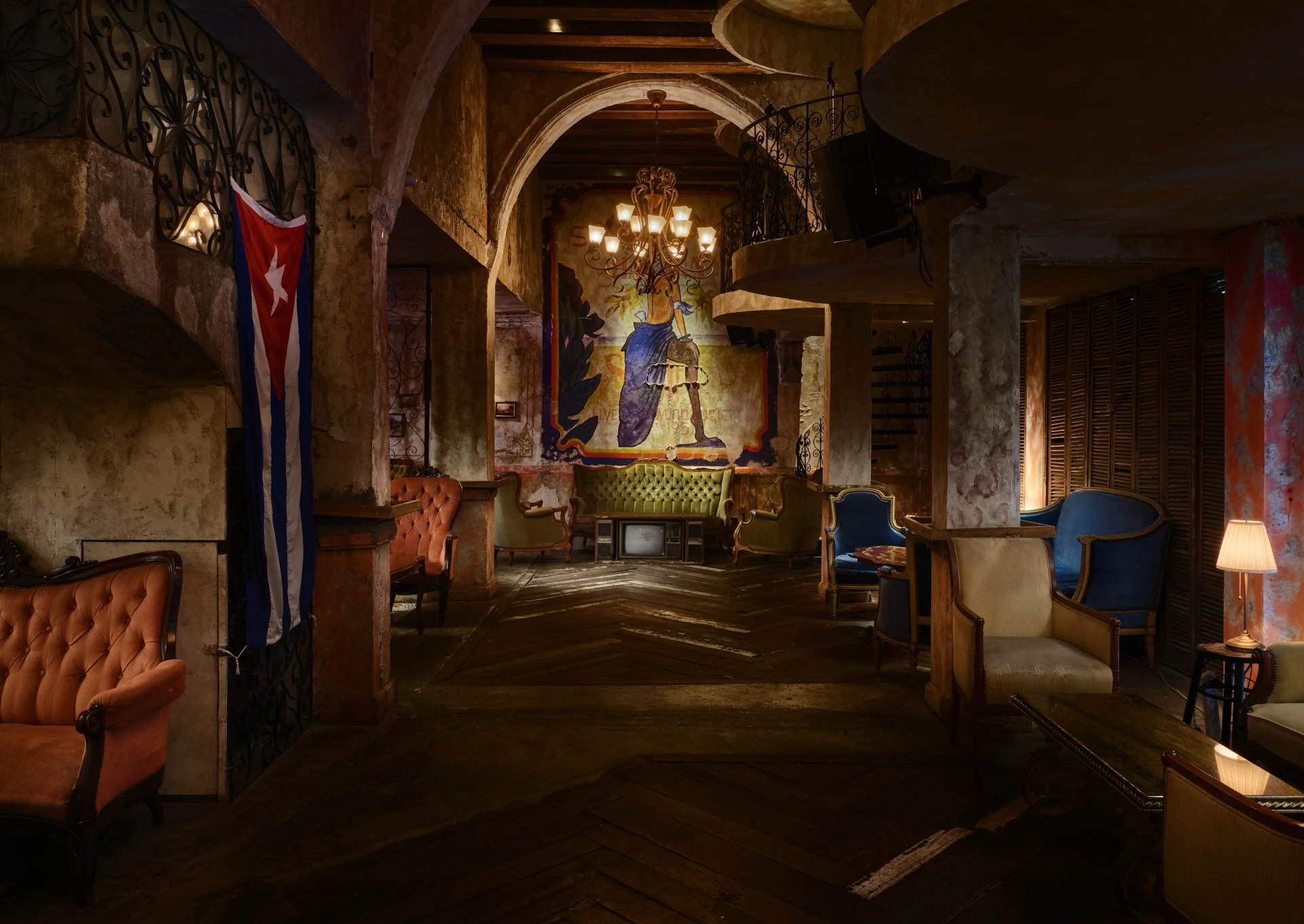 Havana mural corridor with Cuban flag, iron mezzanine and velvet sofas — Havana Social Bangkok restaurant photography