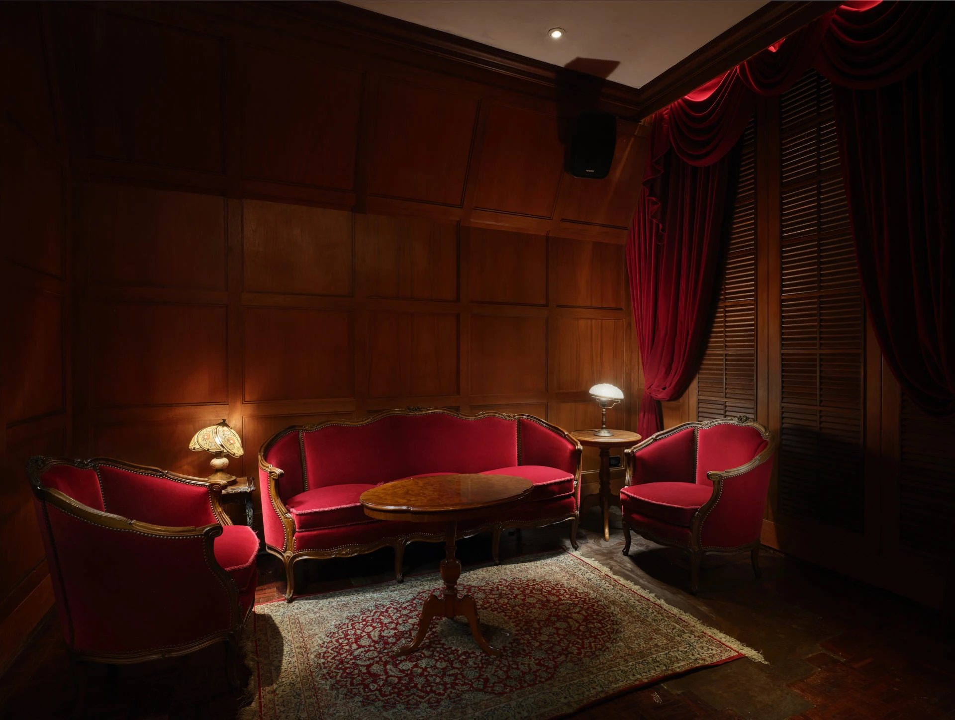 VIP parlor with mahogany panels, red velvet furniture and Tiffany lamps — Havana Social Bangkok interior photography