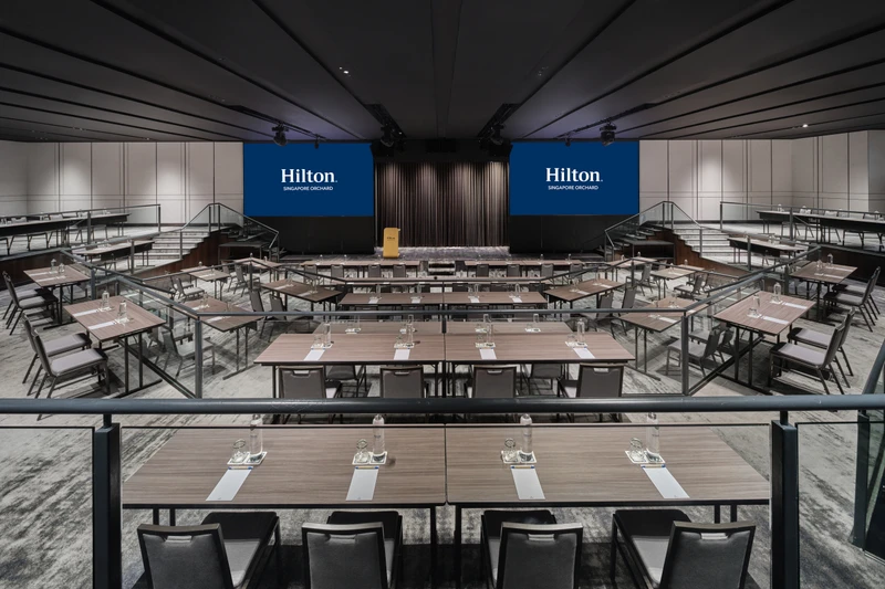 Hilton Singapore Orchard Imperial Ballroom in classroom setup with modern hotel meeting room seating and integrated presentation screens