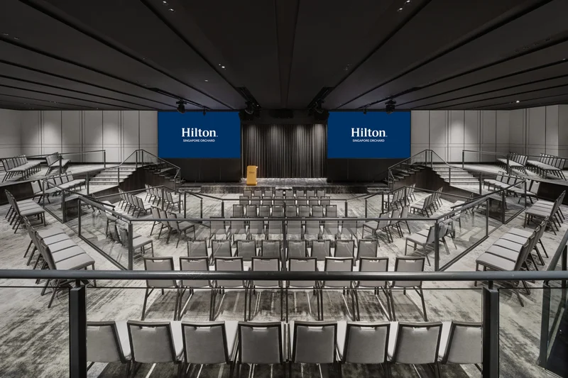 Hilton Singapore Orchard Imperial Ballroom in theatre setup with modern hotel meeting room seating and integrated presentation screens