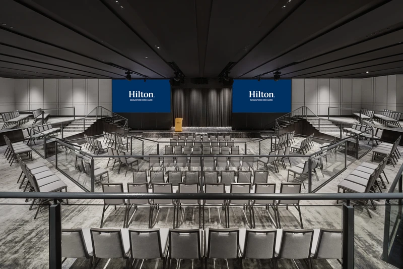 Hilton Singapore Orchard Imperial Ballroom in theatre setup with modern hotel meeting room seating and integrated presentation screens