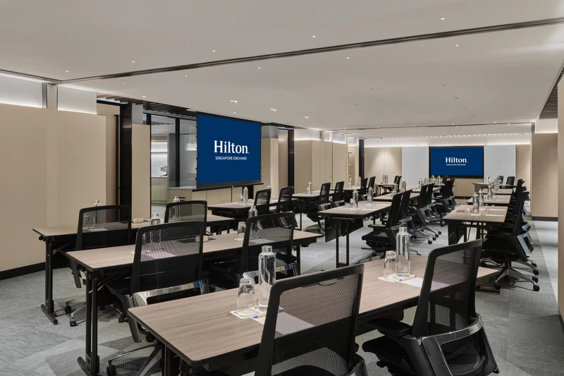 Hilton Singapore Orchard Level 5 Mahogany in classroom setup with modern hotel meeting room seating and integrated presentation screens