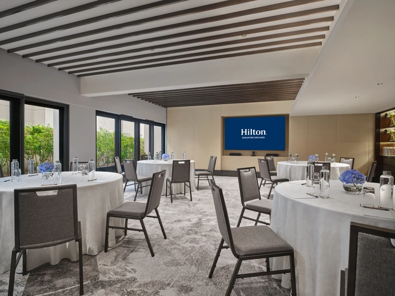 Hilton Singapore Orchard Level 8 Amaryllis in cluster setup with modern hotel meeting room seating and integrated presentation screens