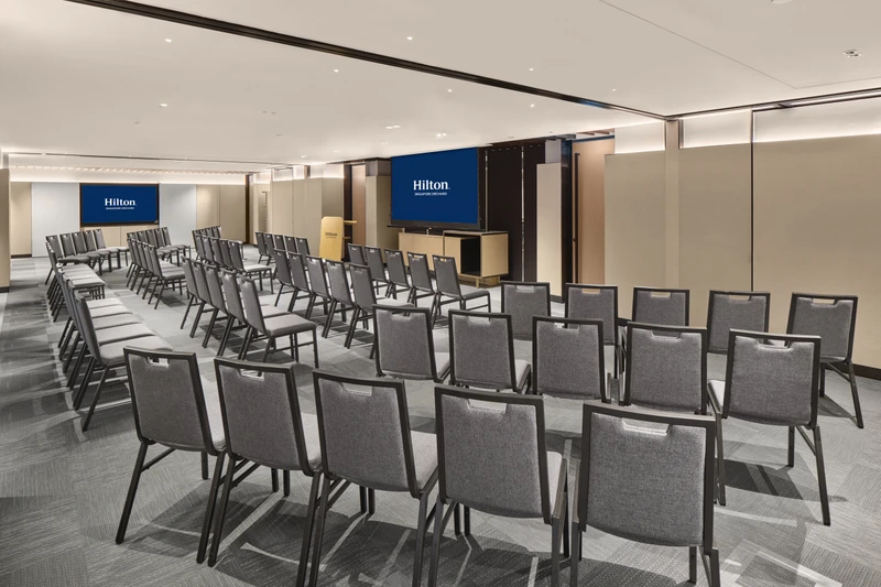 Hilton Singapore Orchard Mahogany in theatre setup with modern hotel meeting room seating and integrated presentation screens