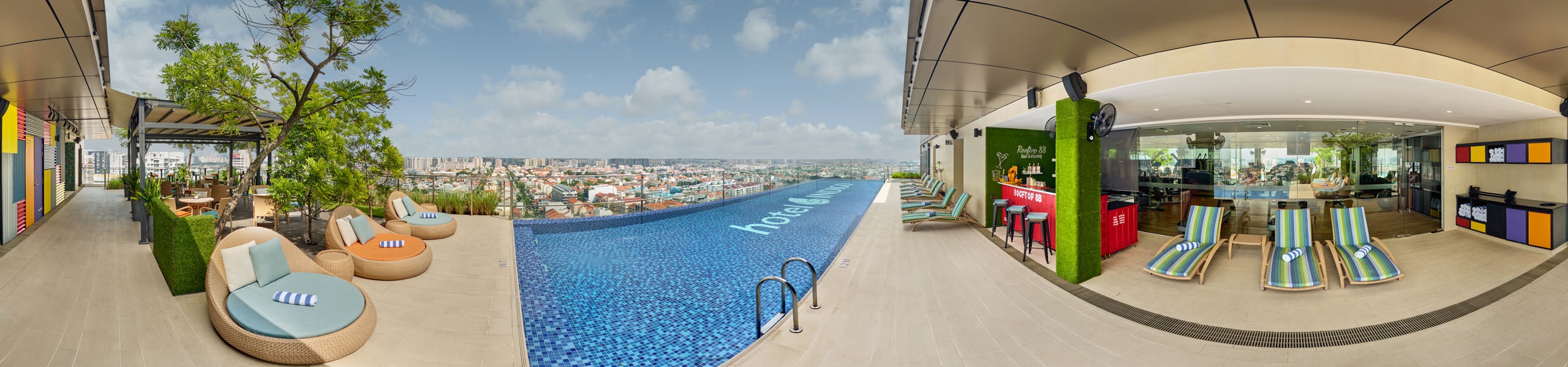 360 panorama of Hotel Indigo Singapore Katong rooftop pool with colourful loungers and neighbourhood views