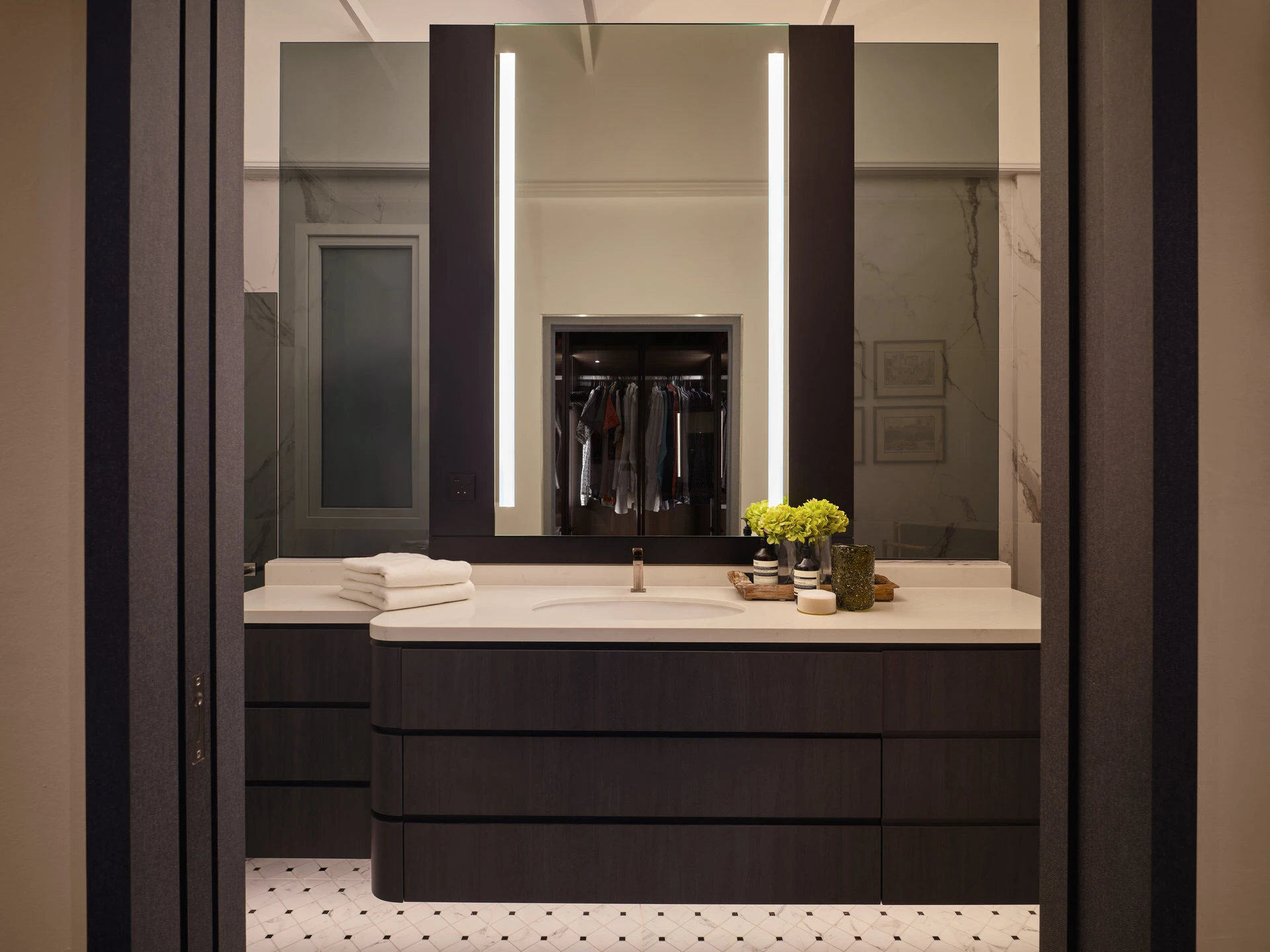 Dark timber vanity with marble walls and LED mirror strips - Holland Green Singapore residential bathroom photography
