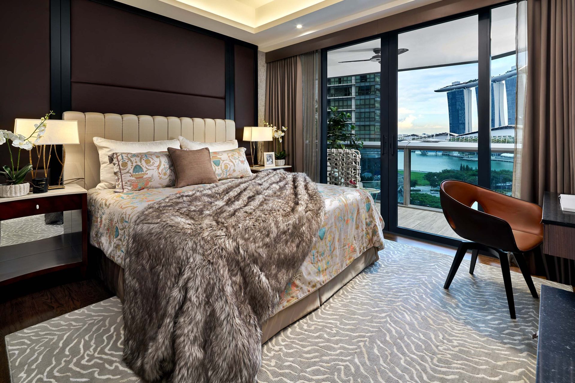 Spacious master bedroom with city views and stylish decor