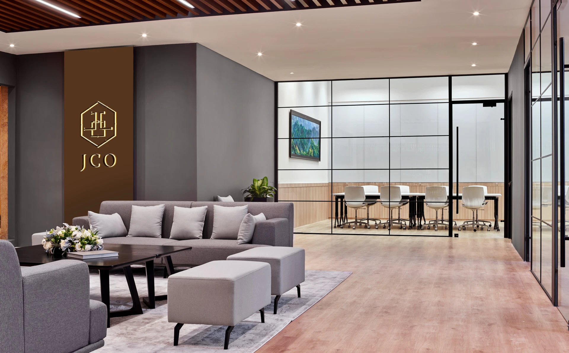 Reception lounge with illuminated gold logo and blush area rug