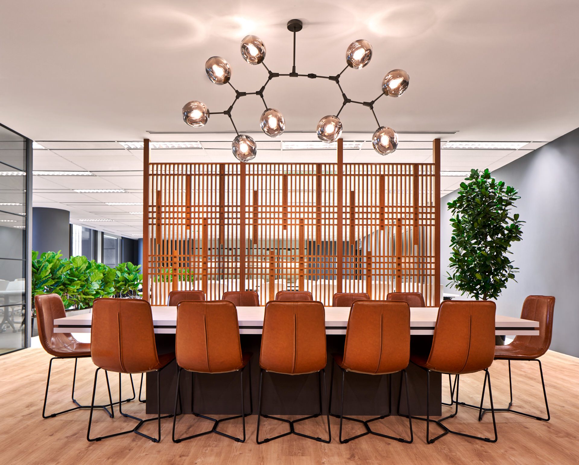 Communal dining table with Japanese lattice screen and molecular chandelier