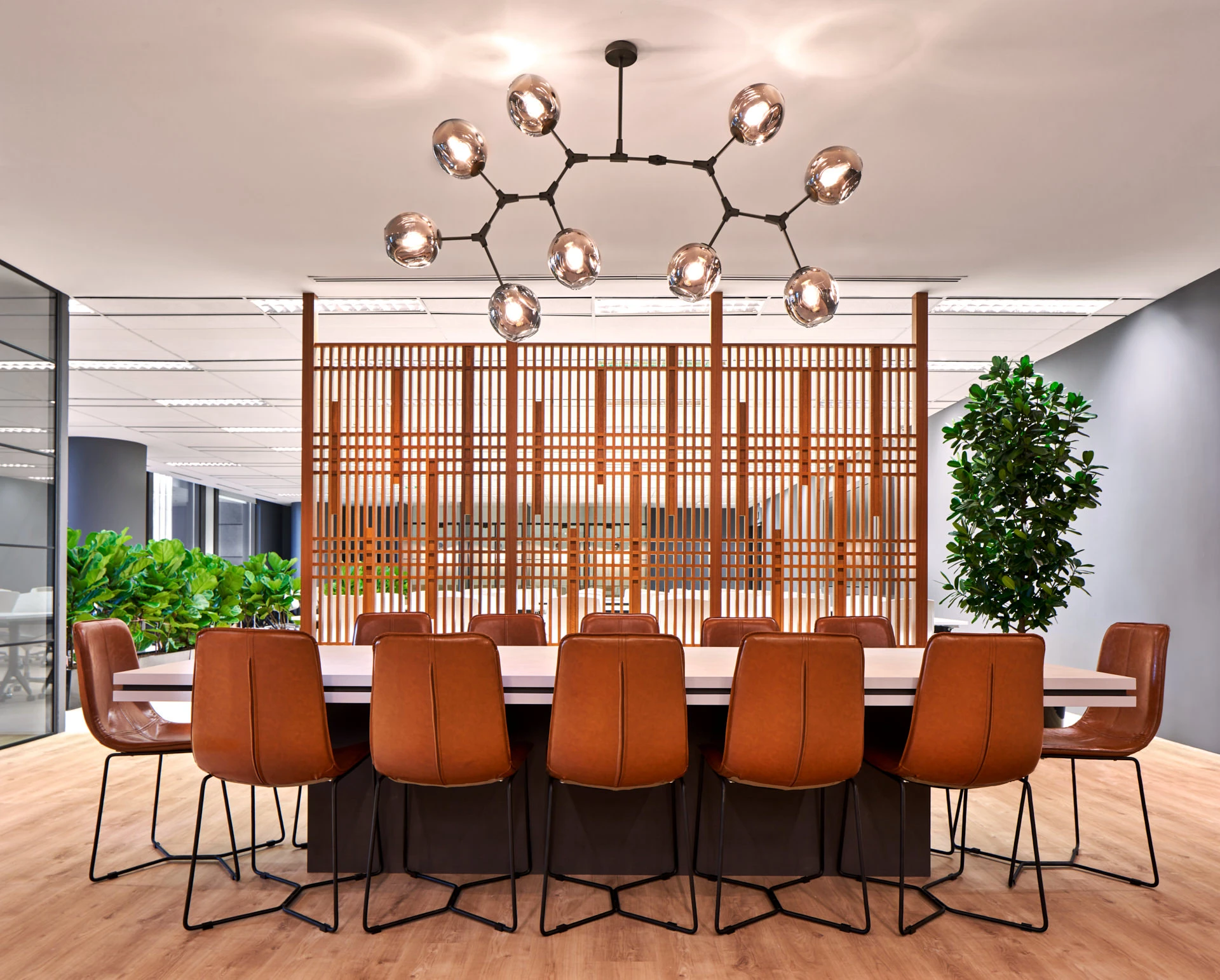 Communal dining table with Japanese lattice screen and molecular chandelier