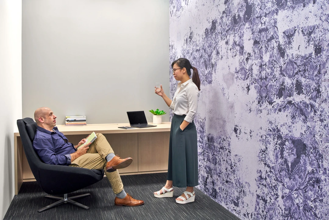 Breakout nook with purple floral feature wall and floating timber ledge