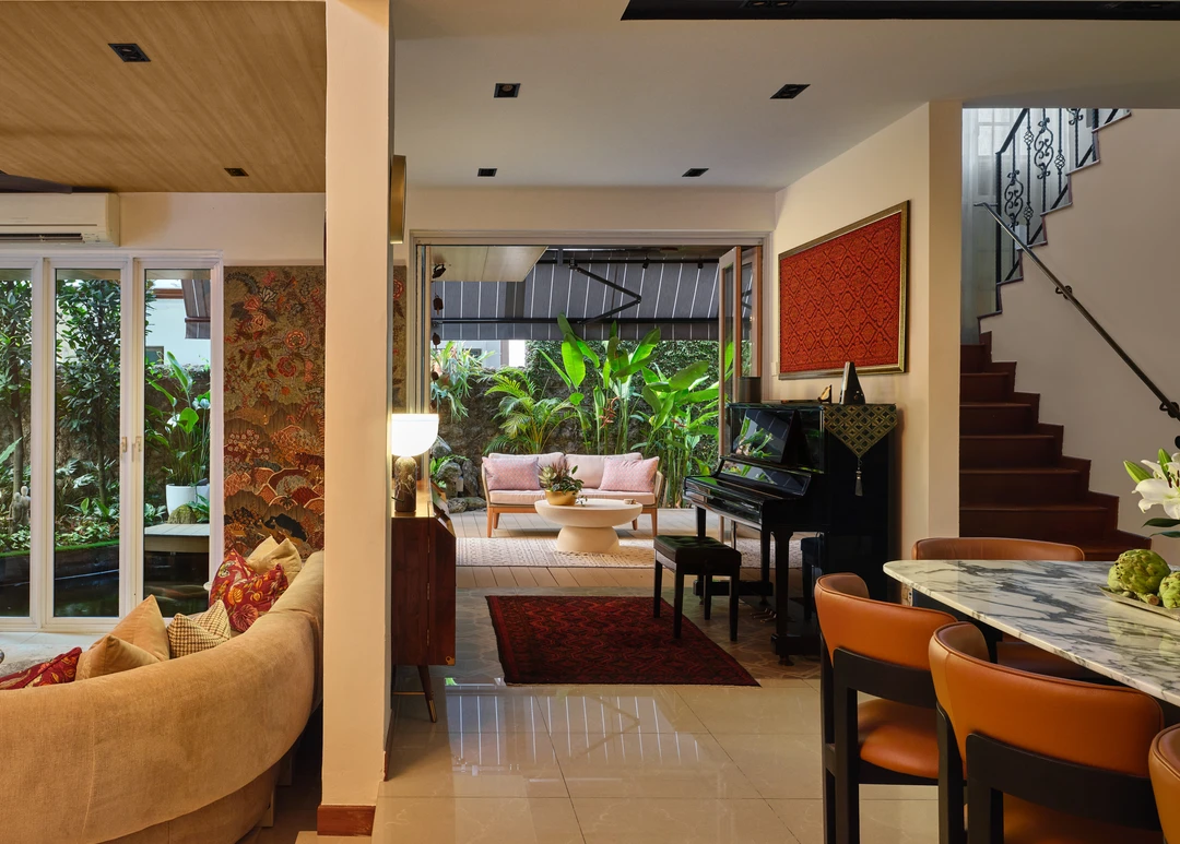 Open-plan Serangoon Chuan Drive residence by Nidhi Jain connecting dining area, lounge, staircase and garden-facing living room
